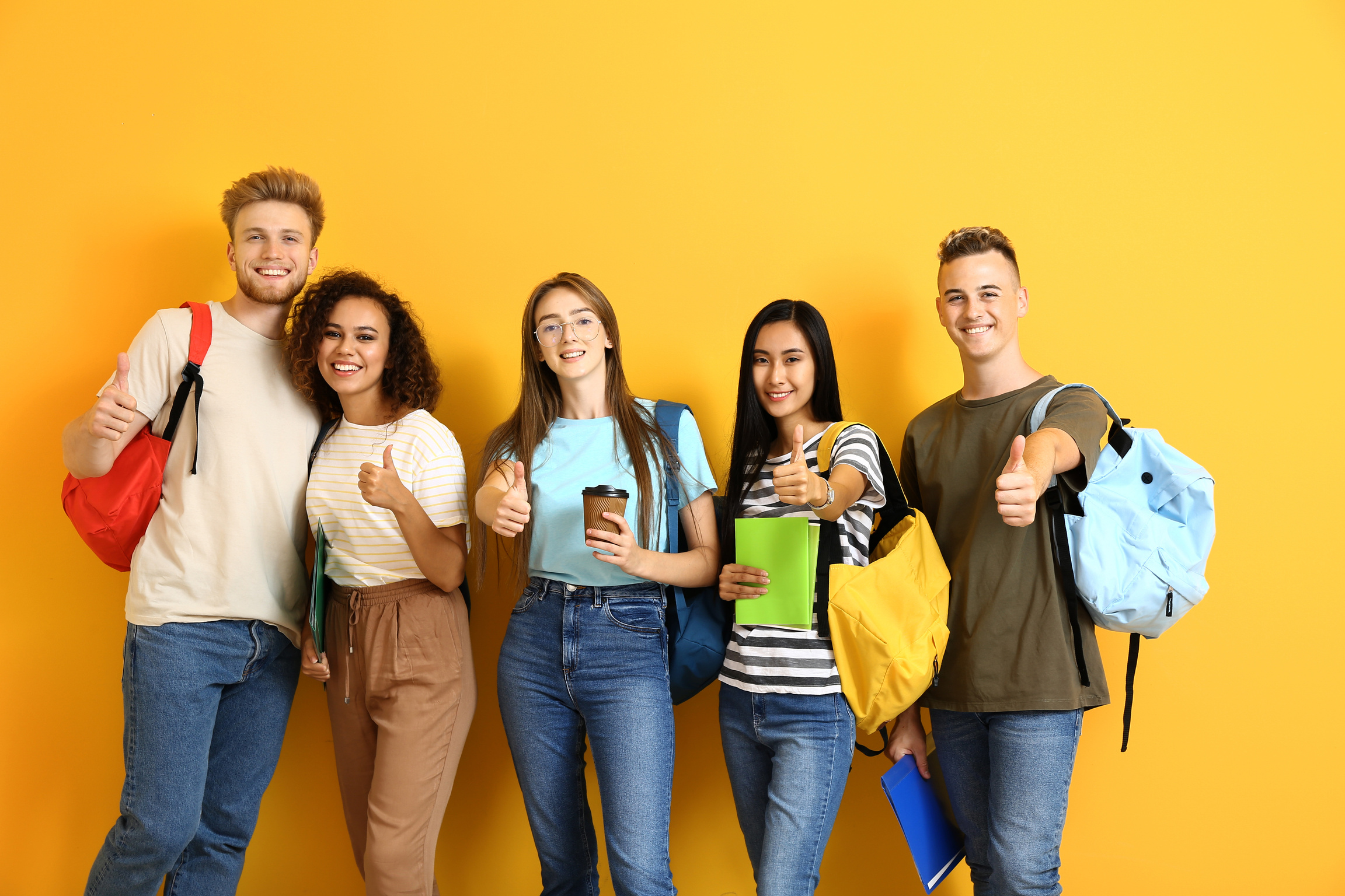 Students Showing Thumb-up Gesture on Yellow Background
